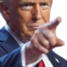 Donald Trump pointing his index finger directly at the viewer with a serious expression.