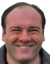 Tony Soprano wearing a wide, smug, and slightly menacing grin.