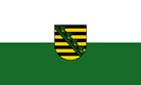 Flag of Saxony with the coat of arms centered on a white and green horizontal background.