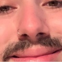 Person with a mustache and nose ring looking slightly distressed.