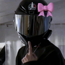 Person wearing a black motorcycle helmet with a reflective visor and a pink bow, gesturing with a middle finger.