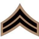 Corporal rank insignia consisting of two black chevrons on a tan background.