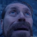 Willem Dafoe looking upward with a shocked and intense expression.