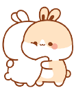 Two cute bunnies hugging each other tightly.