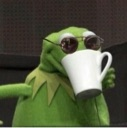 Kermit the Frog wearing sunglasses and holding a white mug to his mouth.