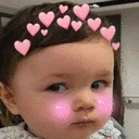 A toddler with a heart crown filter giving a skeptical side-eye glance.