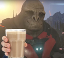 Craig the Brute from Halo holding up a glass of chocolate milk in a toast.