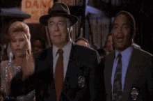 Frank Drebin from The Naked Gun performs a dramatic facepalm in a crowded room.