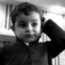 A young child with a perplexed expression scratching their head in confusion.