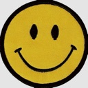 Smiley face with a simple black grin and oval eyes on a yellow background.