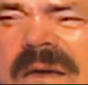 Man with a mustache making a skeptical, squinting face of pure confusion.