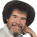 Bob Ross smiling gently with his signature afro and beard.