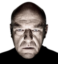 Hank Schrader looking directly at the camera with a stern, intensely frustrated expression.