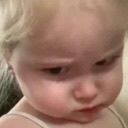 Toddler giving a skeptical side-eye look with an unimpressed expression.