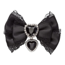 Black satin bow featuring two sparkling heart-shaped charms hanging in the center.