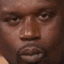 Shaquille O'Neal making a skeptical, side-eye facial expression.