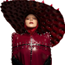 Lady Gaga wearing a large dark hat and red outfit with a serious expression.