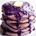 Stack of purple ube pancakes topped with a pat of melting butter.