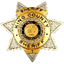 Sheriff badge with a star shape and gold and silver metallic finish.