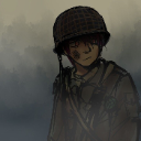 Soldier wearing a helmet with a tired and grim expression.