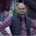 Man standing with hands on hips looking disappointed and impatient.