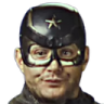 Man wearing a black tactical helmet with a star emblem looking at the camera with a confused and slightly unhinged expressio…