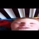 A person's face in a blurry, low-quality close-up with a confused expression.