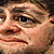 Man's face with a skeptical and slightly distorted smirk.