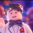 Lego minifigure in a tuxedo looking shocked with wide eyes.