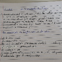 Handwritten note on paper with messy ink scribbles and text.