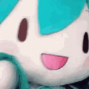Hatsune Miku plushie waving its hand with a happy, smiling expression.