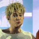 A man with blonde hair makes a skeptical, pouting face with squinted eyes.