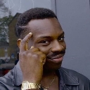 Man tapping his temple with a smug, knowing smile.