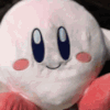 Kirby plush toy being repeatedly punched by a human hand.