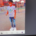 A person standing in a playground with extreme red and blue color distortion.