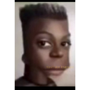 A person with a heavily distorted, elongated head looking directly at the camera with a confused expression.