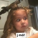 A toddler with a confused and skeptical expression while having their hair styled.