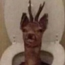 A deer head with antlers looking confused while sitting on a toilet.