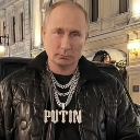 Vladimir Putin wearing a large, diamond-encrusted chain that says PUTIN in bold letters.