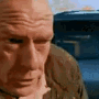 Hank Schrader looking frantic and distressed while exiting a car.