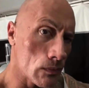 Dwayne The Rock Johnson staring intensely with one eyebrow raised in a suspicious expression.