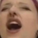 Person with an open mouth and squinted eyes expressing intense shock or disbelief.