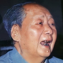 Mao Zedong with a slightly open mouth and serious expression.