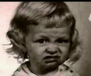 Child with a scrunched up face expressing extreme disgust or skepticism.