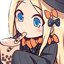 Abby with blonde hair and a witch hat calmly sipping boba tea.