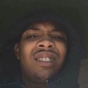 G Herbo wearing a dark hoodie with a skeptical and smug facial expression.