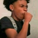 A young person looking to the side while covering their mouth with their hand to suppress a laugh.