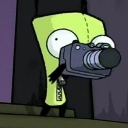 Gir from Invader Zim holding a camera up to his face.