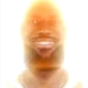 A man's face with a wide grin, heavily overexposed and glowing with intense white and orange light.
