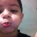 Young boy making a skeptical face with pursed lips.